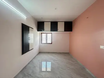 an empty room with orange and white walls at House of KRM - Nilgiris Outlook in Kāramadai