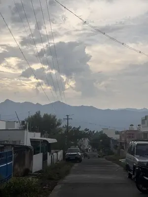 a street with cars parked on the side of the road at House of KRM - Nilgiris Outlook in Kāramadai