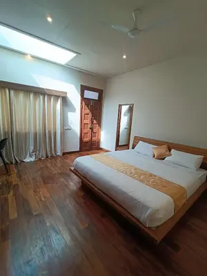 a bedroom with a large bed in a room at Sky16cafe in Kushālnagar