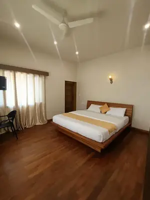 a bedroom with a large bed in a room at Sky16cafe in Kushālnagar