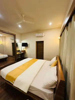 a bedroom with a large bed in a room at Sky16cafe in Kushālnagar