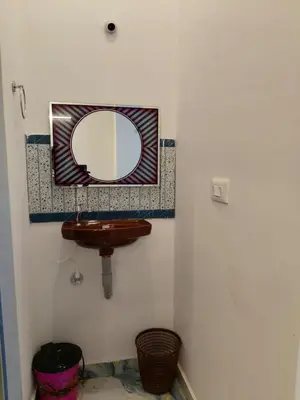 a bathroom with a mirror and a sink at Nakshatra Home Stay in Vattavada