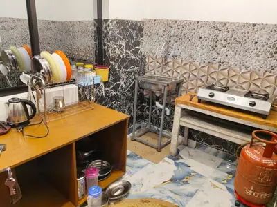 a kitchen with a counter and a stove in a room at Nakshatra Home Stay in Vattavada