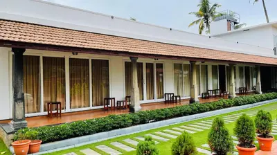a building with tables and chairs in a courtyard at Breakwater Palace in Cochin
