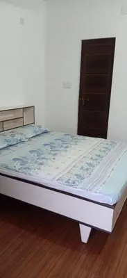 a bed in a room next to a door at Garden Beach in Cochin