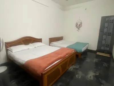 a bedroom with two beds in a room at PK Homestay in Coimbatore