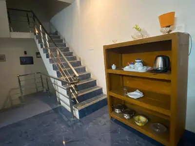 a spiral staircase in a room with a shelf at PK Homestay in Coimbatore