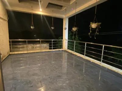 a room with a balcony at night with lights at PK Homestay in Coimbatore