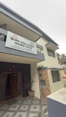 a building with a sign that reads wils well conserve home serve at Roshan's Welcome Home Stay in Mysore