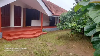 a house with a pathway to the front of it at Stay with Lakeview Ponnampet in Ponnampet