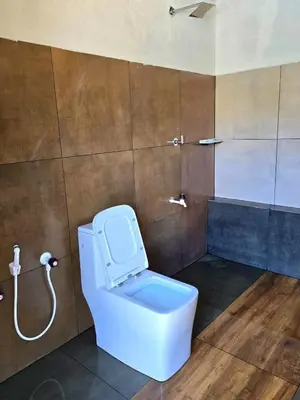 a bathroom with a toilet and a shower at 50 Fables Vintage Kerala Pool Home in Pulpally