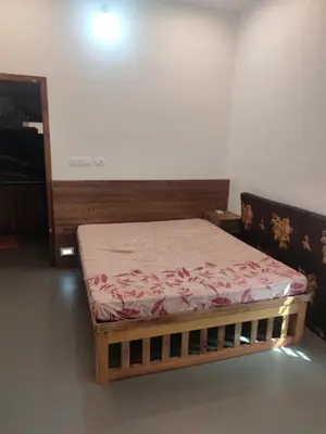 a small bed in a room with at AANMEEZ Homestay in Kuthuparamba