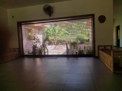 a large window with a dog standing behind it at AANMEEZ Homestay in Kuthuparamba