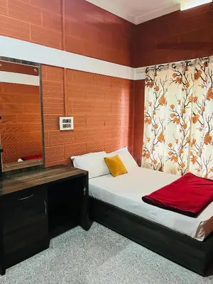 a bedroom with a bed and a desk in it at Spillway private pool villa in Meenangadi