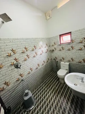 a bathroom with a toilet and a sink at Spillway private pool villa in Meenangadi