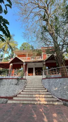 a building with stairs in front of a house at Spillway private pool villa in Meenangadi