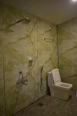 a bathroom with a shower and a toilet at Rays Of Bliss Boutique Resort in Mananthavady