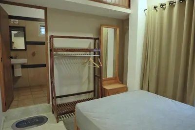 a bedroom with a bed and a shower and a sink at Vista Chembra Service Apartment 20A in Meppādi