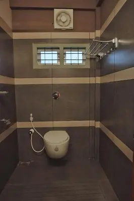 a bathroom with a toilet and a shower at Vista Chembra Service Apartment 20A in Meppādi