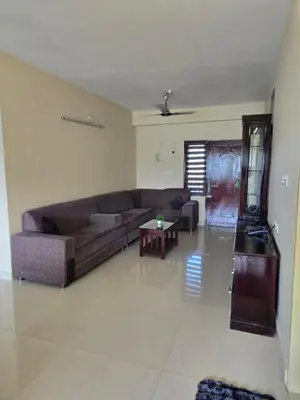 a living room with a couch and a table at The Western Castle Apartment - 2BHK Apartment in Kannur