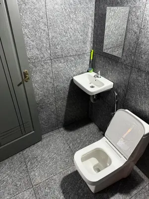 a bathroom with a toilet and a sink at Spice garden farm stay in Kodali