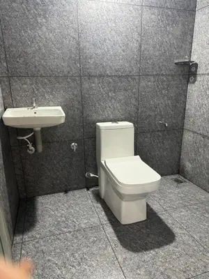 a bathroom with a toilet and a sink at Spice garden farm stay in Kodali