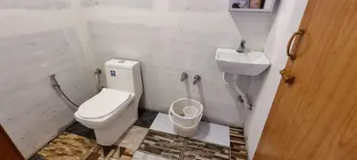 a bathroom with a toilet and a sink at Paalm view premium resort in Kanthalloor