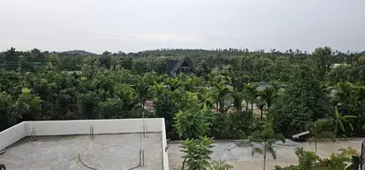 an aerial view of a banana plantation with a house at Ambience Retreat in Sivasamudram