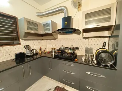 a kitchen with stainless steel cabinets and a stove at shalom 3bhk in Mysore