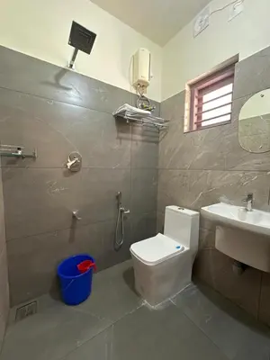 a bathroom with a toilet and a sink at Honeymoon Holidays in Vythiri