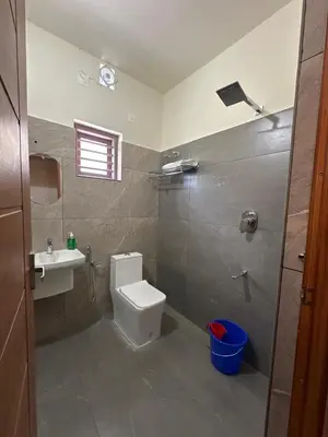 a bathroom with a toilet and a sink at Honeymoon Holidays in Vythiri