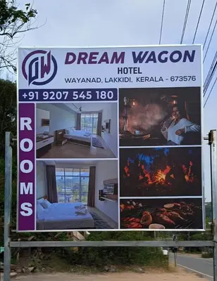 a sign for a dream wagon hotel at Dreamwagon hotel lakkidi in Vythiri