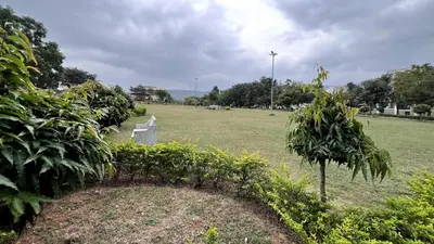 a grave in a field with a cemetery at Aasana A tranquil space by the hills in Mysore