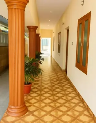 a hallway with a column in a building at Sai Sadan Residency in Lakkidi