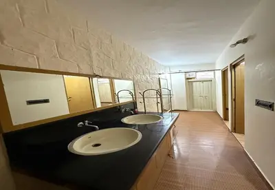 a bathroom with two sinks and a large mirror at Enteveedu Homestay in Panamaram