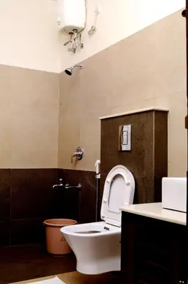 a bathroom with a toilet and a sink and a shower at Enteveedu Homestay in Panamaram