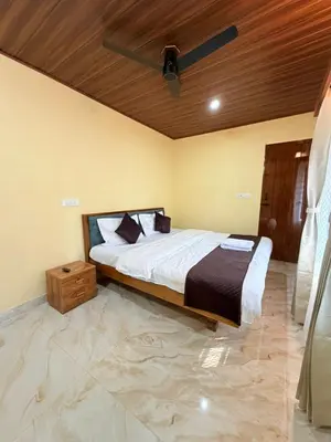 a bedroom with a bed and a wooden ceiling at VIVIPRA Habitat, Coorg in Madikeri