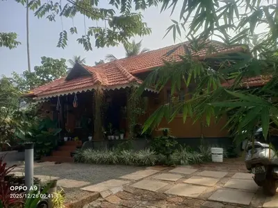 a house with a red roof at Puthooram Veedu in Kannur