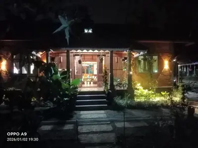 a house at night with the front door lit up at Puthooram Veedu in Kannur