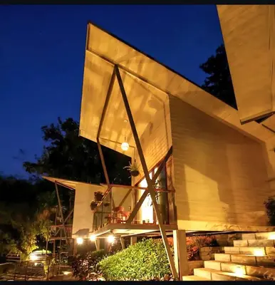 a building with stairs and lights at night at LAKE N DAZE by Masika stays in Ambalavayal