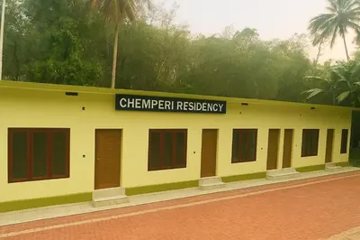 a yellow building with a sign that reads chepper residency at Chemperi Residency in Paithalmala