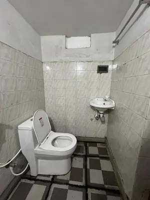a bathroom with a toilet and a sink at VY3 Homes in Vythiri