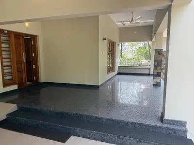 an empty living room with a black tile floor at Premium house near Cochin Airport for NRI families in Nedumbassery