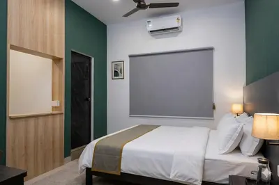 a bedroom with a bed and a large screen at Aldhi Residency in Perintalmanna