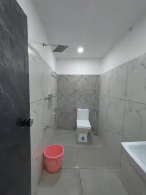 a bathroom with a toilet and a sink and a tub at Aldhi Residency in Perintalmanna