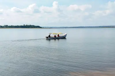 a group of people in a boat on the water at Tiger Woods Homestay Kabini in Antarasante