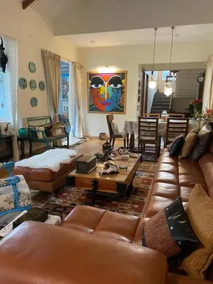 a living room with leather couches and a table at Neom Valley Stays in Ketti