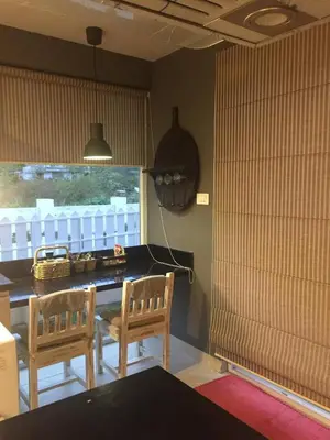 a kitchen with two chairs and a table and a window at Neom Valley Stays in Ketti