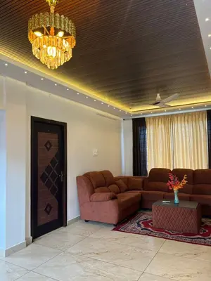 a living room with a couch and a chandelier at Village Villa in Vālpārai