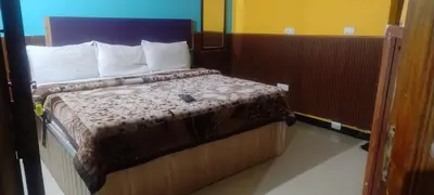 a bedroom with a bed in a room at Suriya Residency in Ooty